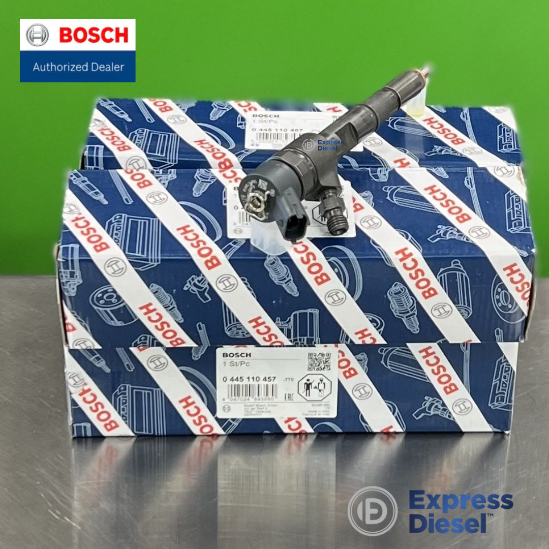 Bosch 0445110457 injector set of 4 - injector resting on the Bosch boxes, nozzle and connector visible