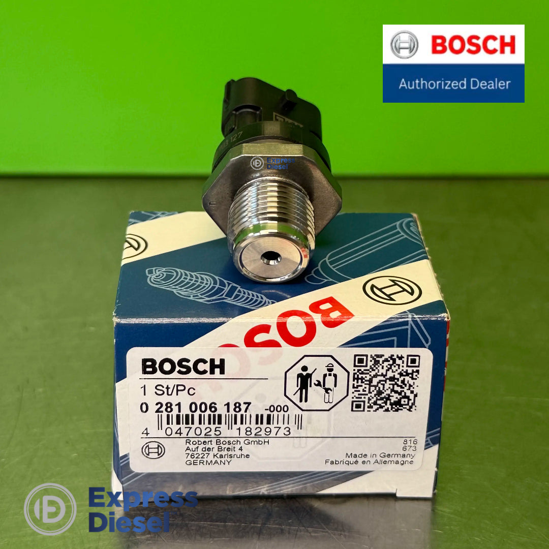 Genuine Bosch 0281006187 rail pressure sensor on original box showing M18 x 1.5 thread and high-pressure port for Renault Nissan 2.0 dCi M9R