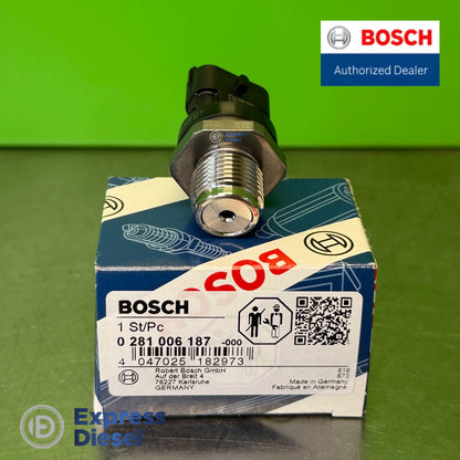 Genuine Bosch 0281006187 rail pressure sensor on original box showing M18 x 1.5 thread and high-pressure port for Renault Nissan 2.0 dCi M9R