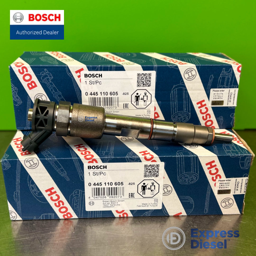 Bosch 0445110605 injector set of 3 - side view on stacked Bosch boxes