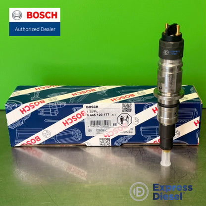 Bosch 0445120177 injector standing upright showing the two-pin solenoid connector, next to the original Bosch box for Cummins QSB 6.7L