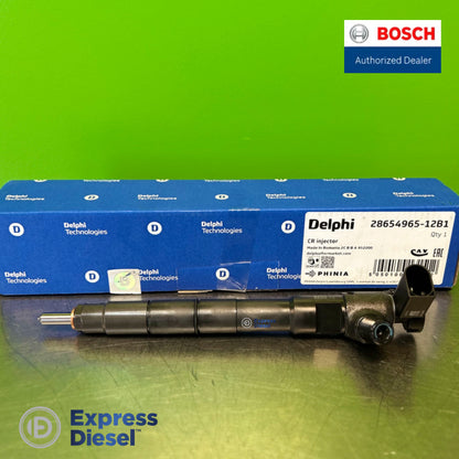 Delphi 28654965 injector lying in front of the original Delphi Technologies box, nozzle view